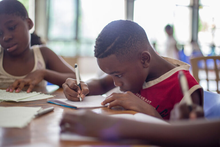 boy writing on paper